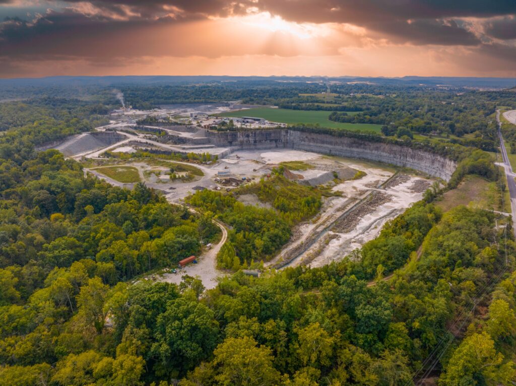 Sunset aerial view of a Kentucky limestone quarry surrounded by forest near Louisville